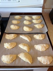 Raw bacon onion turnovers rising.